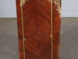 an antique wooden cabinet with a marble top and gold trimmings
