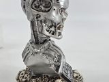 a close up of a statue of a human head with skulls on it
