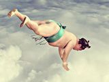 a woman flying through the air in a bikini