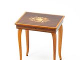 a small wooden table with a flower design on it