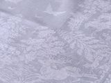 a white table cloth with a floral design on it