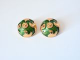 green and gold earrings with floral designs on them