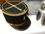 a hat that is sitting on a table next to a kettle
