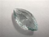 a close up of a green quartz stone on a white surface