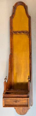 two wooden shelves on the wall with a mirror above them
