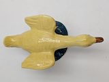 a yellow bird that is sitting on a blue plate