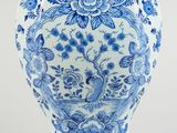 blue and white vase with a bird and flowers on it