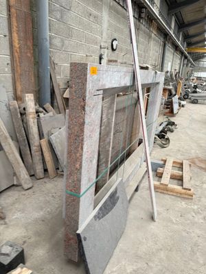 many pieces of granite on the ground in a warehouse