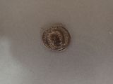 a silver coin with a picture of a man on it