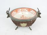 a bowl with antlers on it sitting on a stand