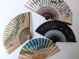 four different types of hand fans on a white surface