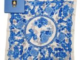 a blue and white handkerchief with blue flowers and butterflies on it