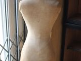 a mannequin in front of a window in a room