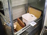 une grande cage métallique contenant un bac de nourriture