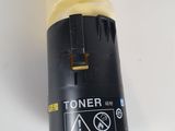a close up of a yellow toner on a white surface