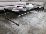 a coffee table with magazines on top of it in a living room