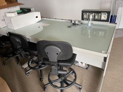 a desk with a chair and a computer on it