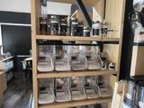 a shelf full of jars and containers in a room