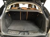 the back of a car with the trunk open and the seats down