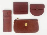 three pieces of brown leather are arranged on a white surface