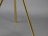a black and gold table lamp on a tripod stand