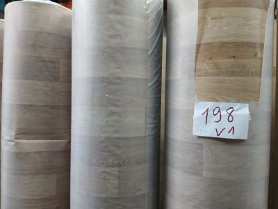 many rolls of paper sitting on a shelf in a warehouse