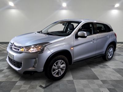 a picture of a silver car parked in a garage