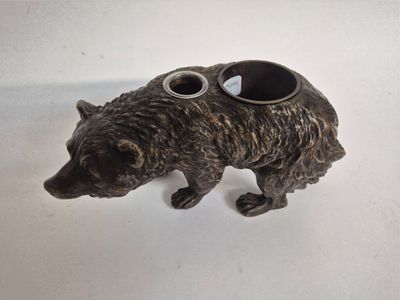 a statue of a bear with goggles on its head