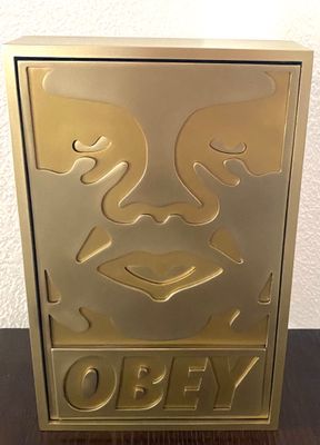 an image of a gold box with a face on it