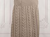 a beige cable knit cape on a mannequin mannequin mannequin mannequin mannequin mannequin mannequin mannequin mann