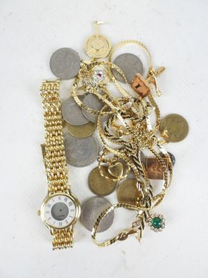 a pile of gold and silver jewelry on a white surface