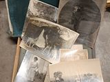 a box full of old photos sitting on the floor