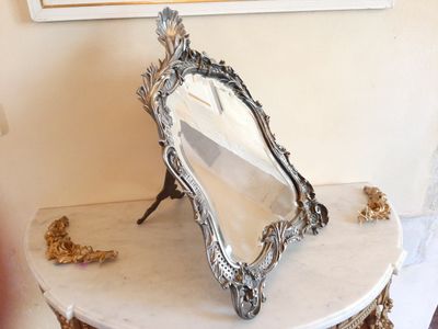 a mirror sitting on top of a table next to a mirror