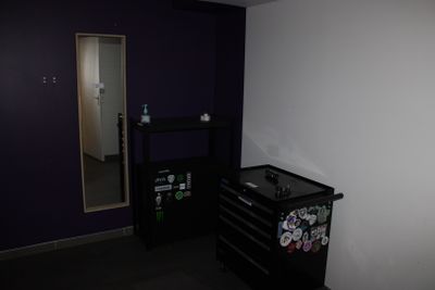 une armoire noire munie d'aimants, dans une pièce