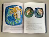 a book with a picture of a mermaid and a cat on it