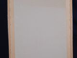 an easel with a blank canvas sitting on top of a wooden stand