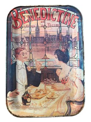 a tin tray with a picture of a man and a woman having a meal