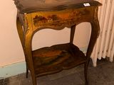 a small table with a shelf on it in a room