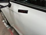 a car with a sticker on the side of it ' s door