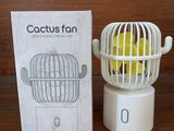 a box with a tennis ball inside of it and a cage with a tennis ball inside of it
