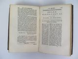 an open book on a white table with a black and white picture