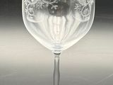 a wine glass with a design on it on a table