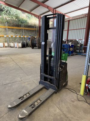 a fork lift truck parked in a warehouse with other equipment