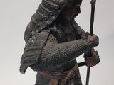 figurine of a samurai with a sword and shield on a white background
