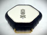 a small black and white box on a white table