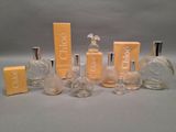 several bottles of perfume sitting on top of a table next to each other