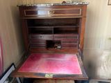 a wooden desk with a marble top in a room