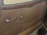 an old car with a door open on the side of the road