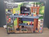a box with a toy grill on it on a wooden table