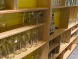 many empty glass jars on the shelves in the store